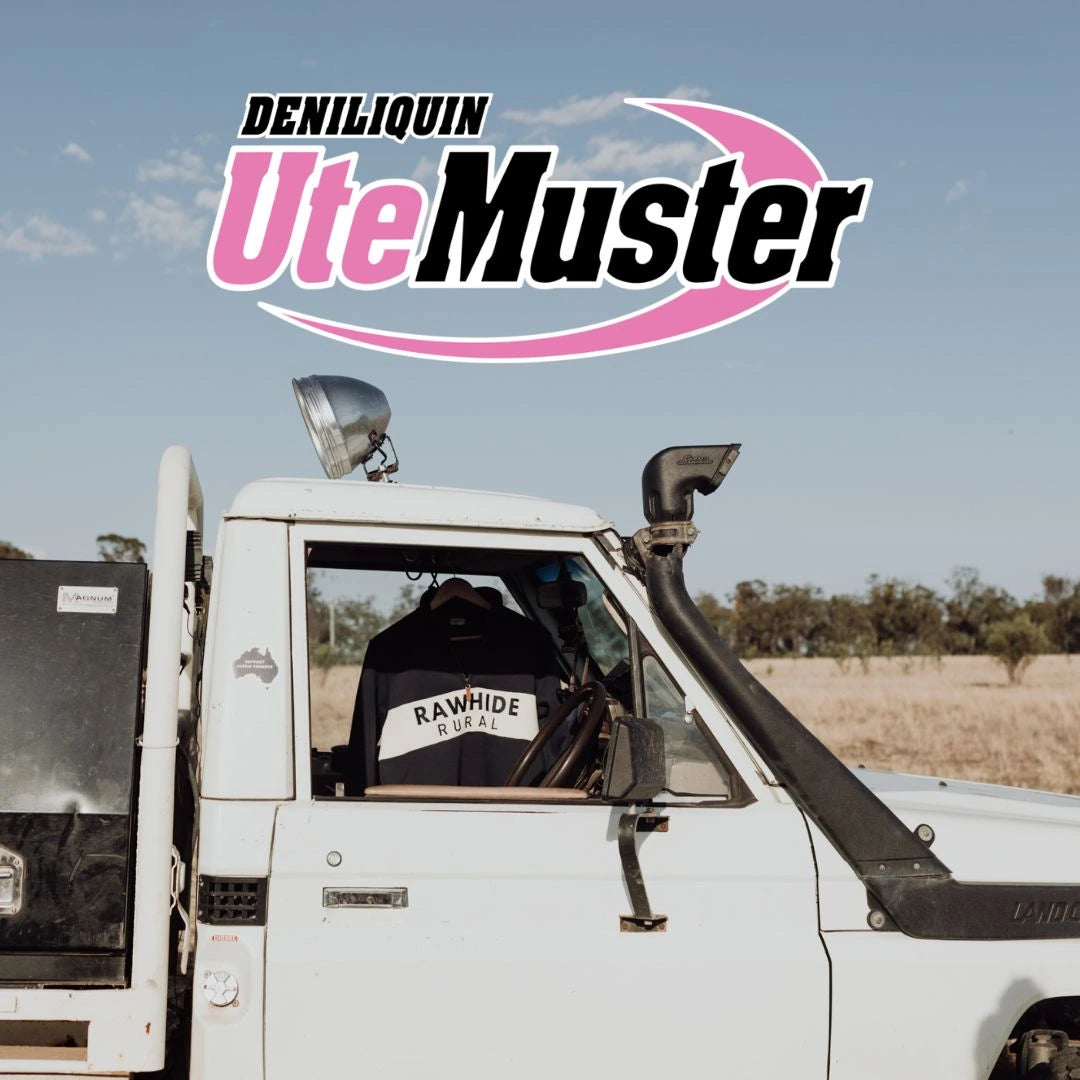 White ute with 'Rawhide' jacket inside, Deniliquin Ute Muster logo above, against a clear sky.