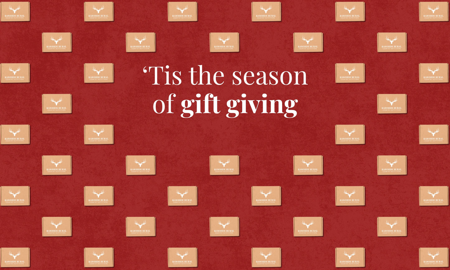 Red background with brown gift boxes and text 'Tis the season of gift giving'